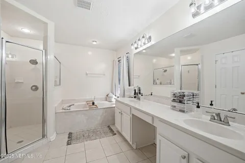 a bathroom with a double vanity sink mirror double and shower