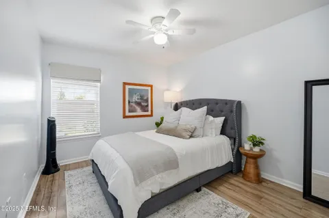 a bedroom with a large bed and a chandelier