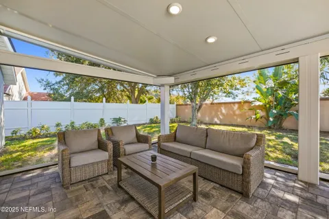 a outdoor living space with furniture and a floor to ceiling window