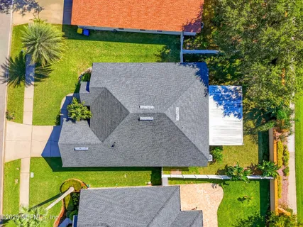 an aerial view of a house with a swimming pool