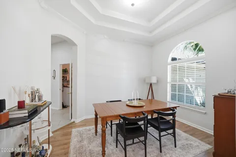 a view of a dining room with furniture and a window