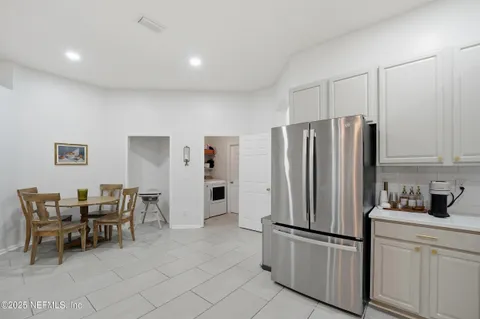 a kitchen with stainless steel appliances a refrigerator and wooden cabinets
