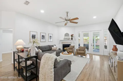 a living room with furniture a fireplace and a flat screen tv