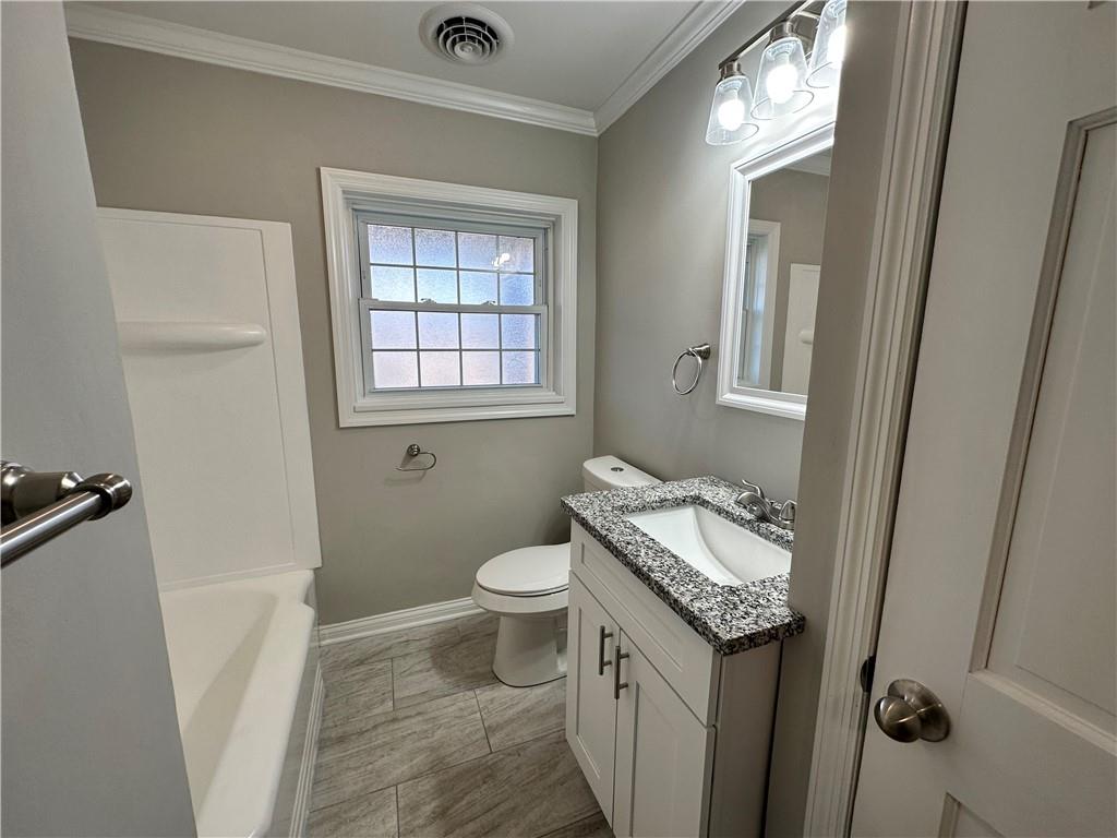 3095 Tuscarawas Road Beaver, PA 15009 - Photo 19 of 25 a bathroom with a granite countertop sink a toilet a window and a mirror