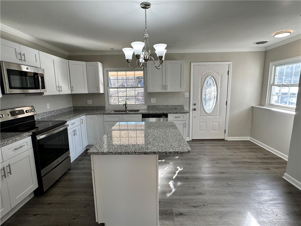 3095 Tuscarawas Road Beaver, PA 15009 - Photo 9 of 25 a kitchen with granite countertop a stove a sink and a microwave