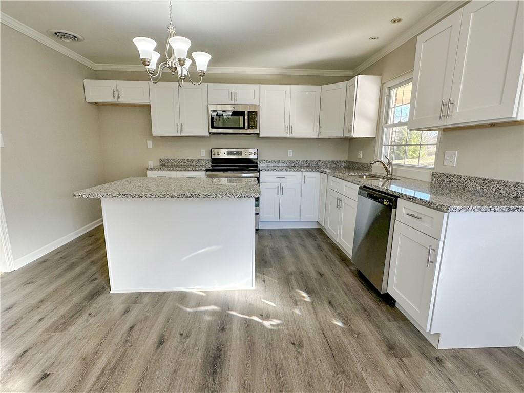 3095 Tuscarawas Road Beaver, PA 15009 - Photo 10 of 25 a kitchen with stainless steel appliances granite countertop a sink dishwasher a stove top oven a refrigerator and white cabinets