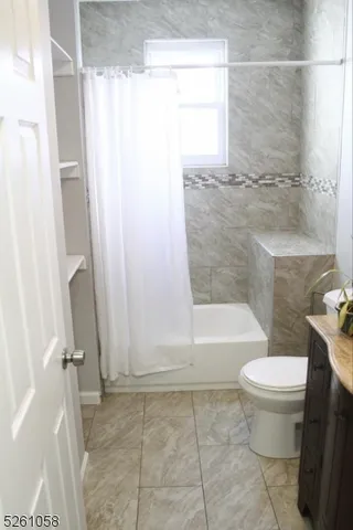 a bathroom with a bathtub and a toilet