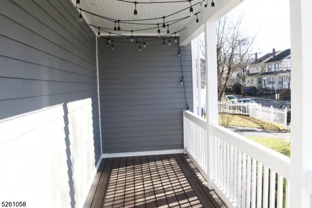 a view of a balcony with a sink and wooden floor