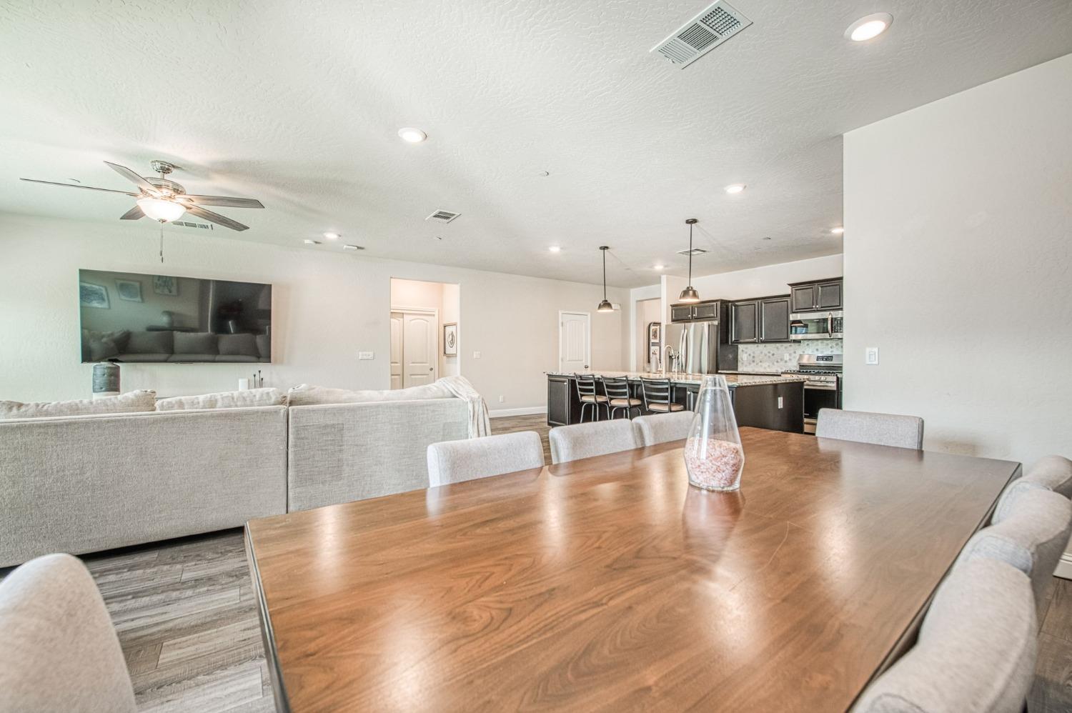 574 Expedition Way Madera, CA 93636 - Photo 16 of 26 a living room with furniture and flat screen tv