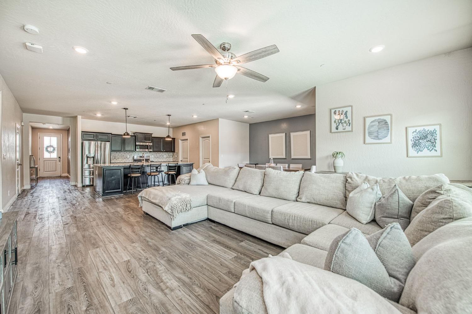 574 Expedition Way Madera, CA 93636 - Photo 17 of 26 a living room with furniture white walls and kitchen view