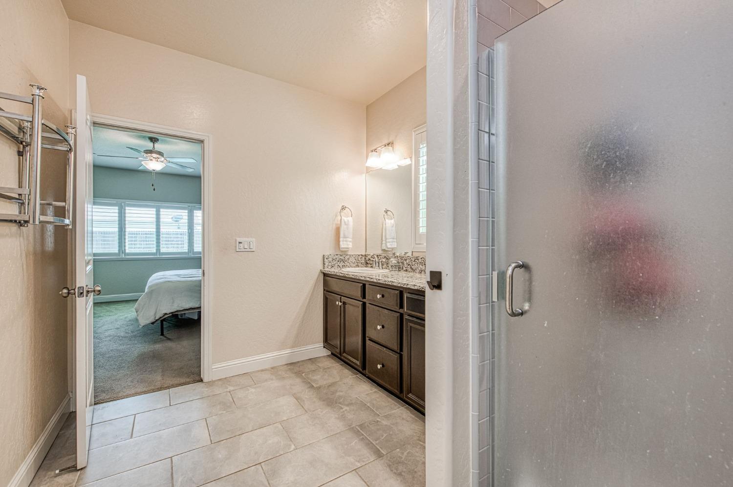 574 Expedition Way Madera, CA 93636 - Photo 21 of 26 a bathroom with a sink and a mirror