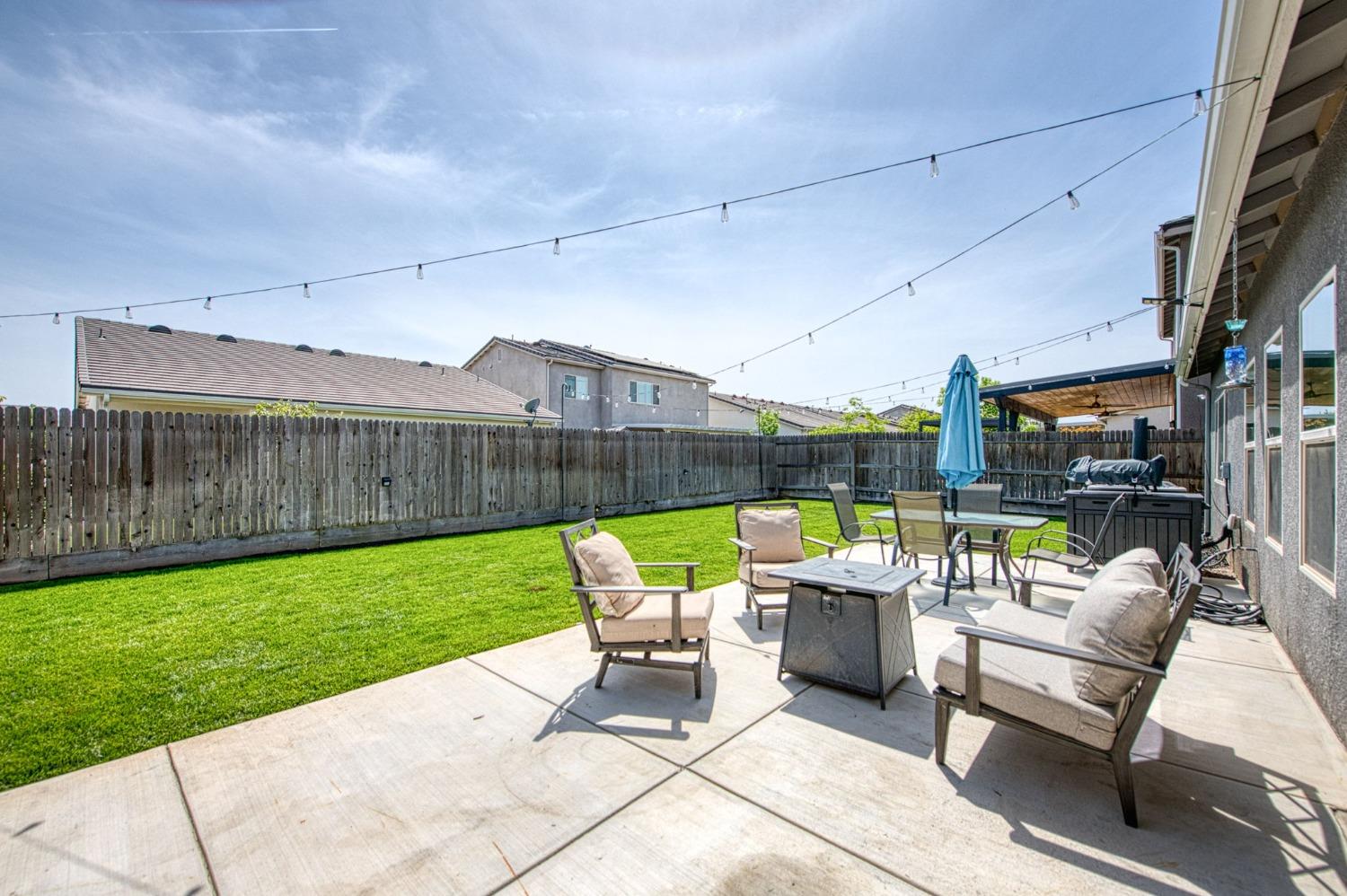 574 Expedition Way Madera, CA 93636 - Photo 24 of 26 a view of a patio with a table and chairs
