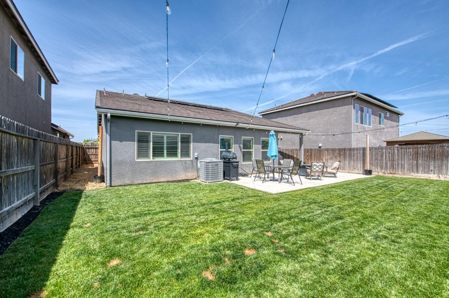 574 Expedition Way Madera, CA 93636 - Photo 26 of 26 a front view of a house with patio and garden