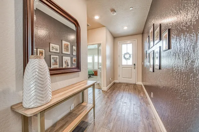 a view of entryway and hall with wooden floor