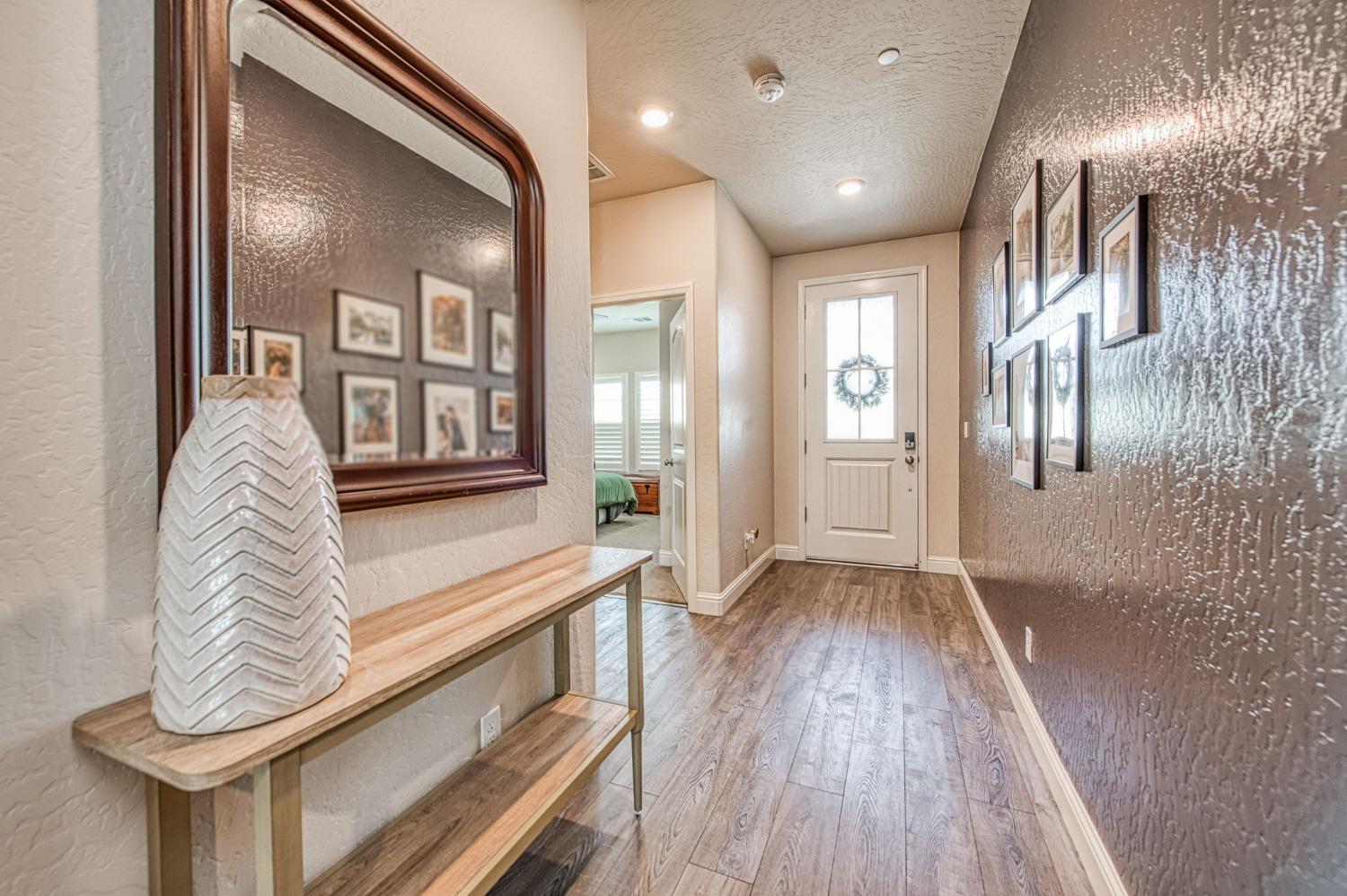 574 Expedition Way Madera, CA 93636 - Photo 3 of 26 a view of entryway and hall with wooden floor