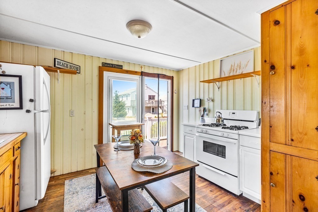 95 River Street Scituate, MA 02066 - Photo 8 of 23 a kitchen with a stove a refrigerator and a dining table