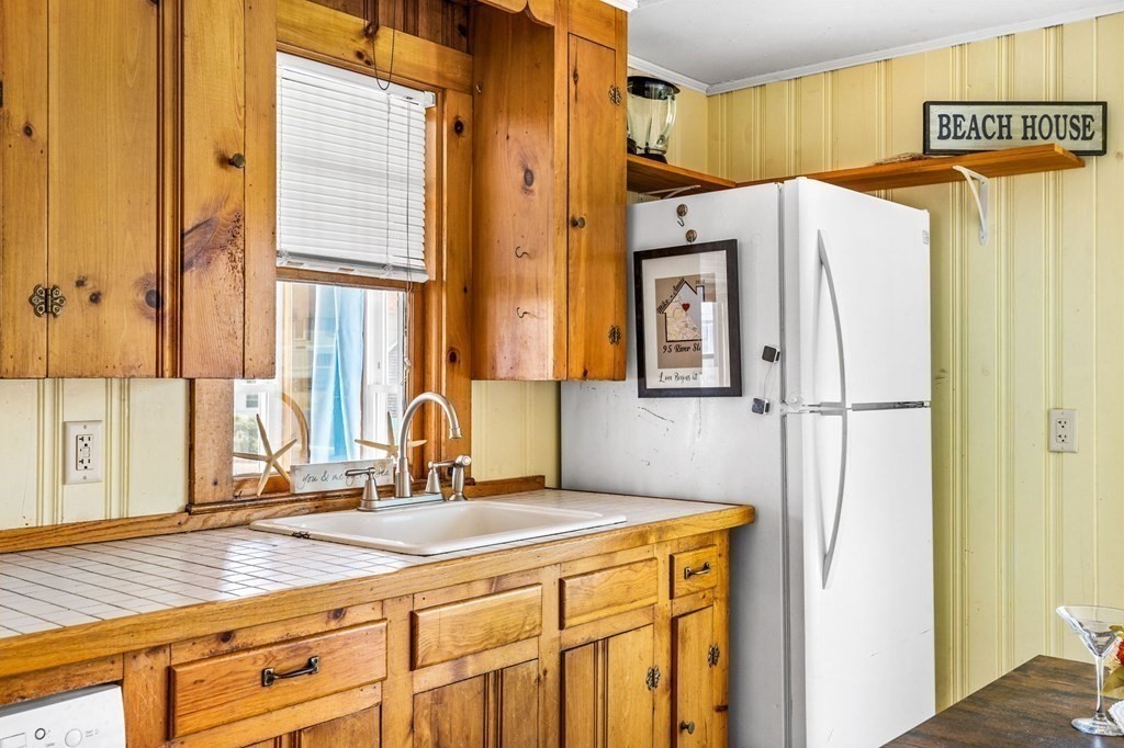 95 River Street Scituate, MA 02066 - Photo 9 of 23 a bathroom with a granite countertop sink and a large mirror