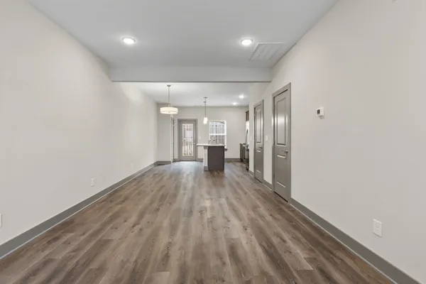 a view of a hallway with wooden floor