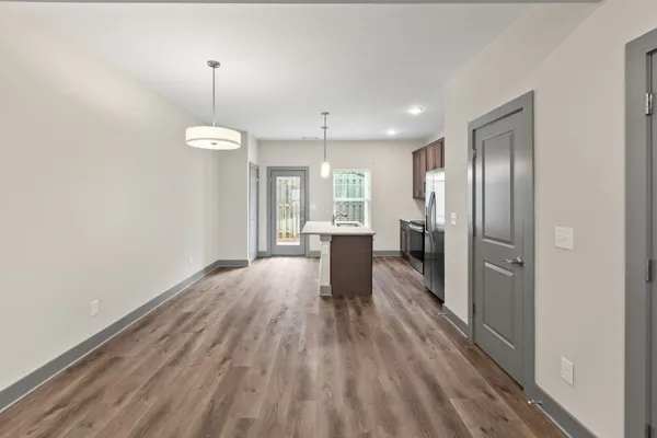 a view of a refrigerator in kitchen and wooden floor