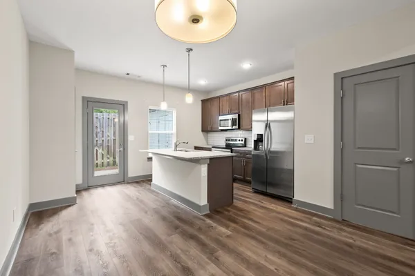 a view of kitchen and hall with wooden floor
