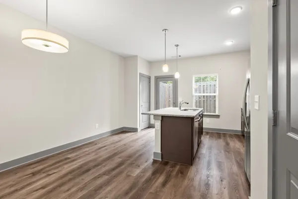 a kitchen with stainless steel appliances granite countertop a kitchen island hardwood floor sink stove and granite counter top