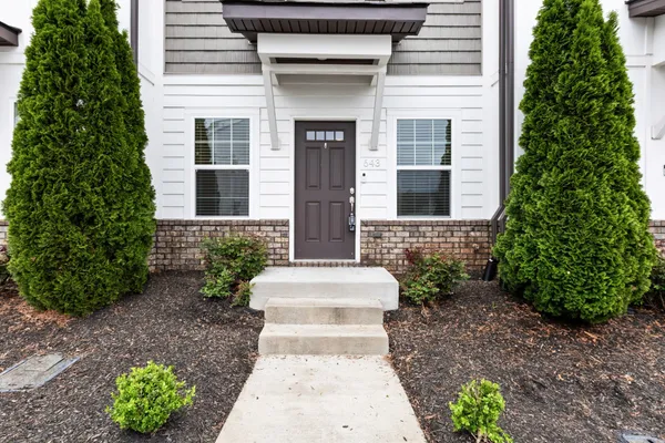 a front view of a house with garden