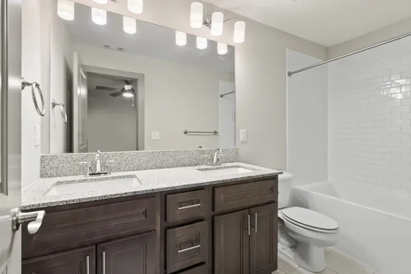 a bathroom with a granite countertop sink a mirror and a