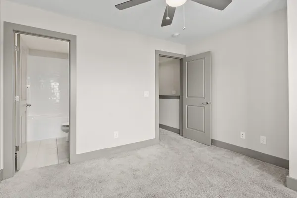 an empty room with chandelier fan