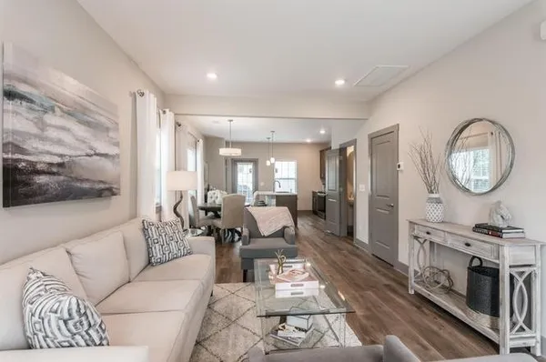 a living room with furniture a mirror and a flat screen tv