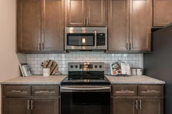 a stove top oven sitting inside of a kitchen