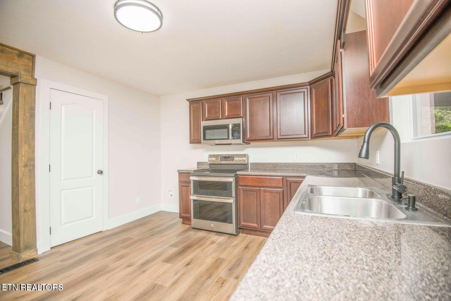 589 Possum Valley Road Maynardville, TN 37807 - Photo 17 of 49 a kitchen with granite countertop a sink cabinets and stainless steel appliances