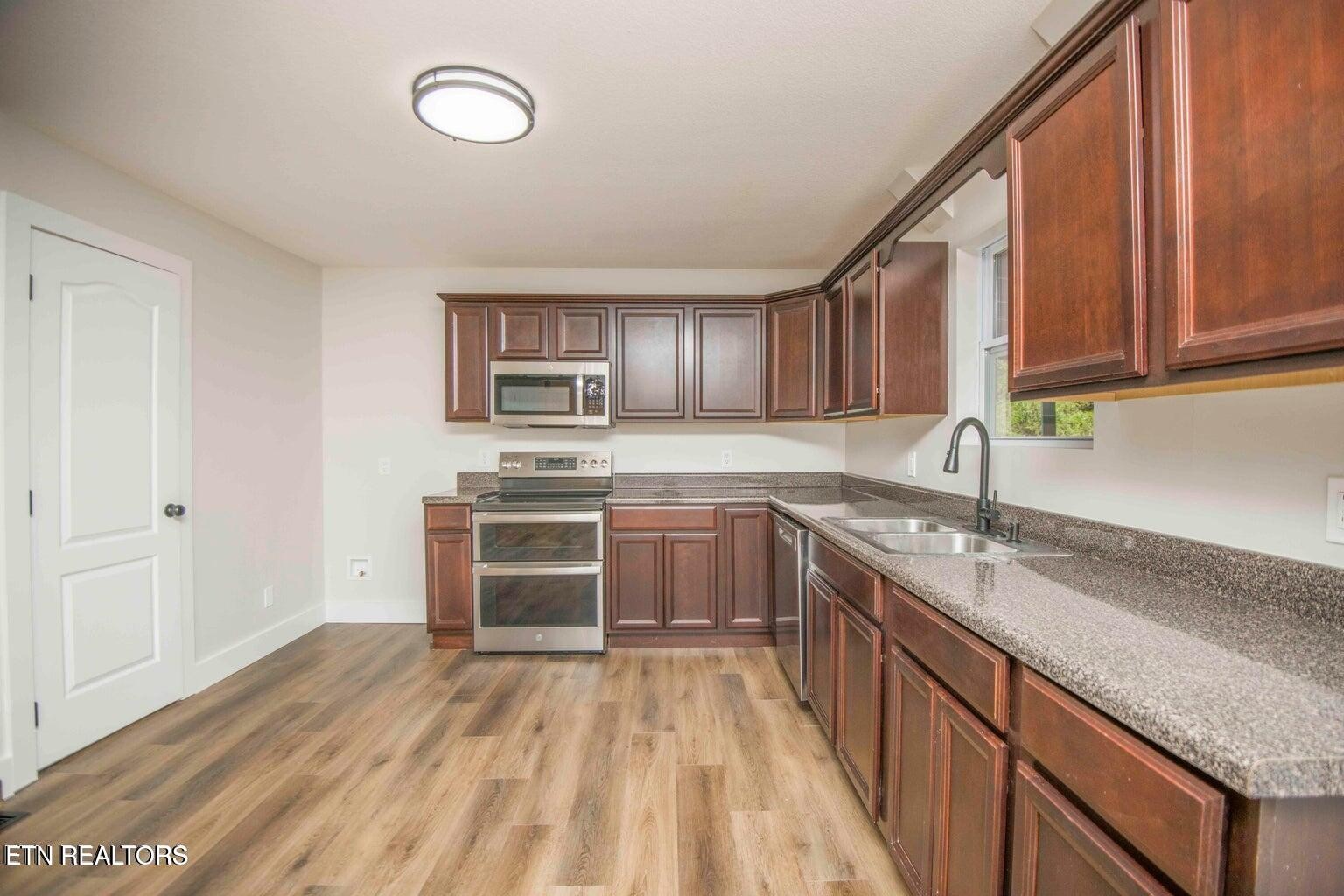 589 Possum Valley Road Maynardville, TN 37807 - Photo 20 of 49 a kitchen with a sink stove and cabinets