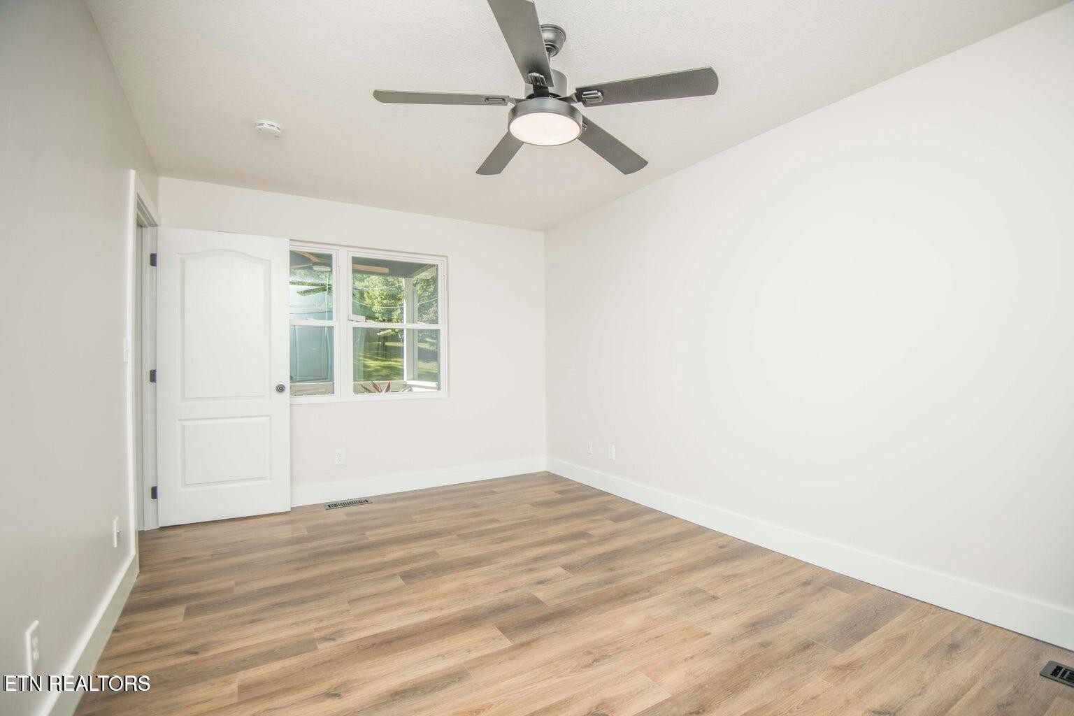 589 Possum Valley Road Maynardville, TN 37807 - Photo 22 of 49 wooden floor in an empty room with a window