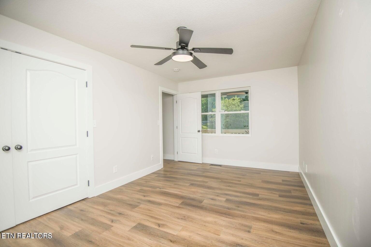 589 Possum Valley Road Maynardville, TN 37807 - Photo 23 of 49 a view of empty room with wooden floor and fan
