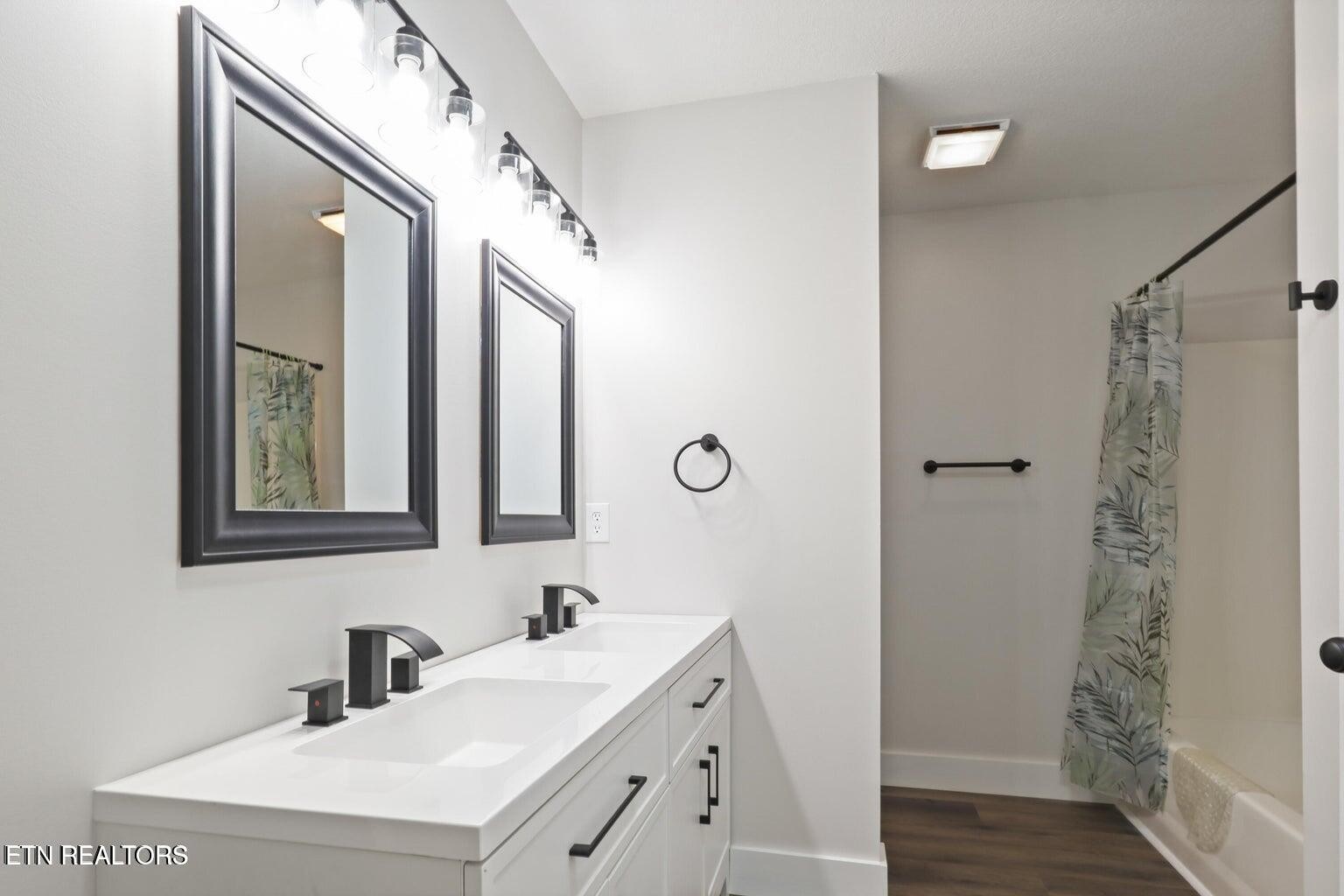 589 Possum Valley Road Maynardville, TN 37807 - Photo 24 of 49 a bathroom with a double vanity sink mirror and shower