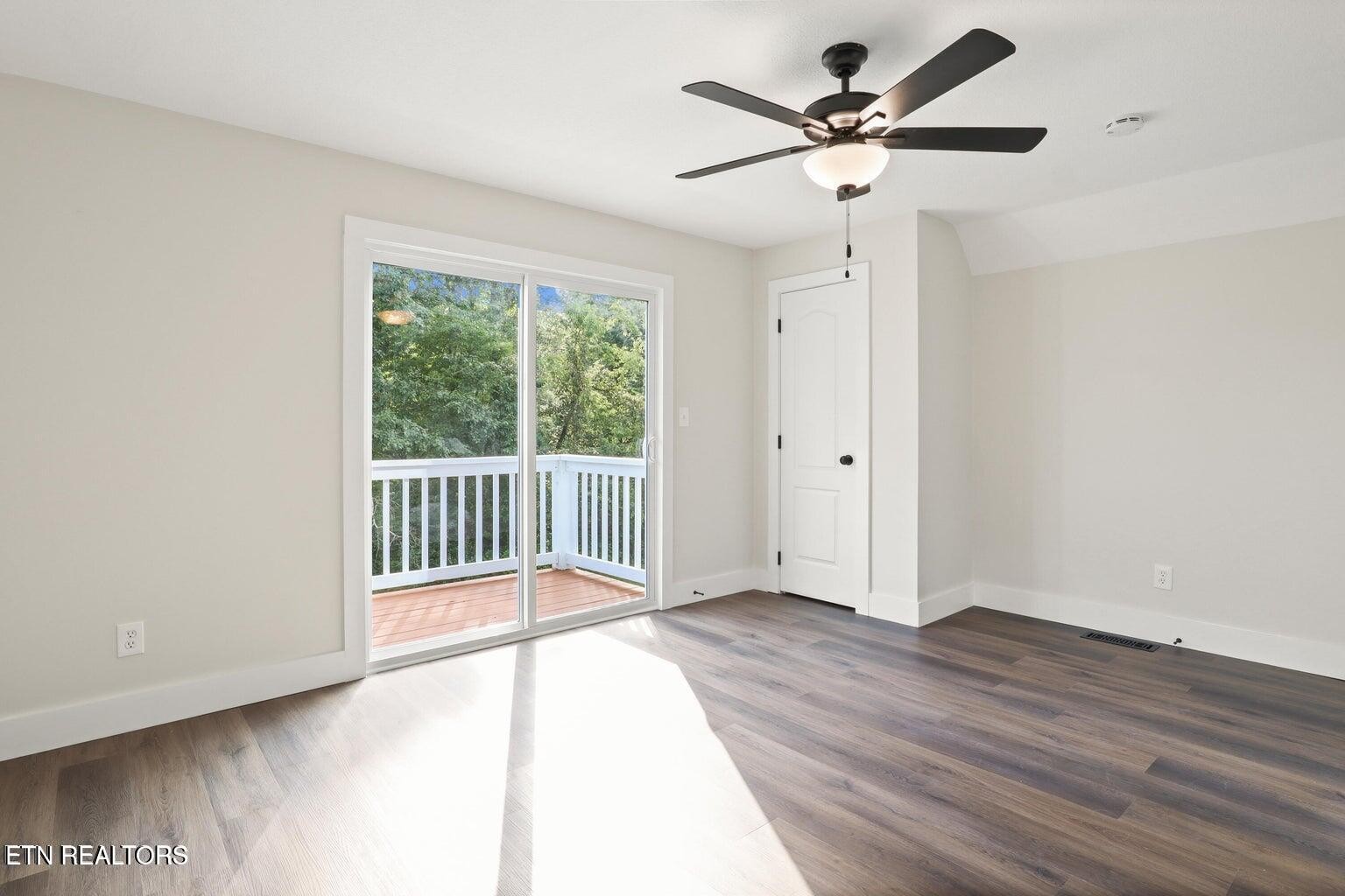 589 Possum Valley Road Maynardville, TN 37807 - Photo 27 of 49 an empty room with wooden floor and windows