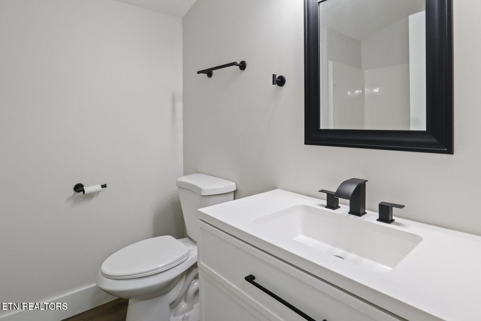589 Possum Valley Road Maynardville, TN 37807 - Photo 32 of 49 a bathroom with a sink a toilet and mirror