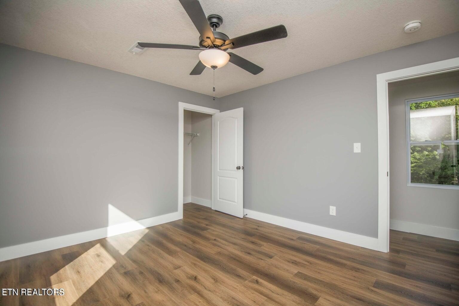 589 Possum Valley Road Maynardville, TN 37807 - Photo 35 of 49 an empty room with wooden floor and fan