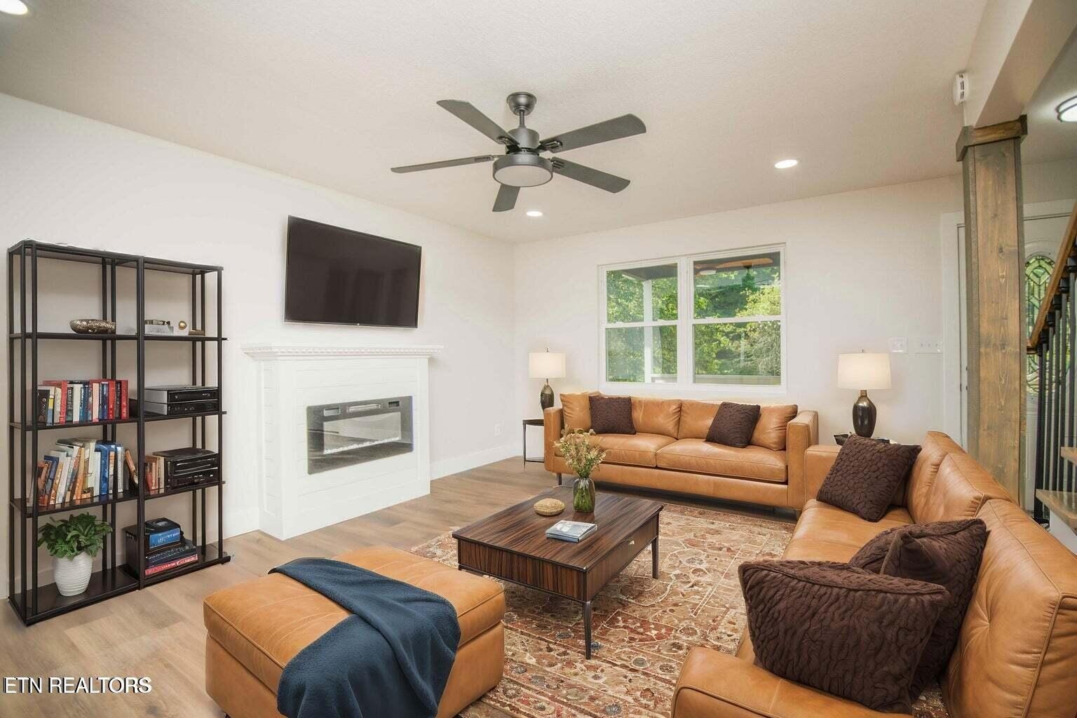 589 Possum Valley Road Maynardville, TN 37807 - Photo 6 of 49 a living room with fireplace furniture and a flat screen tv