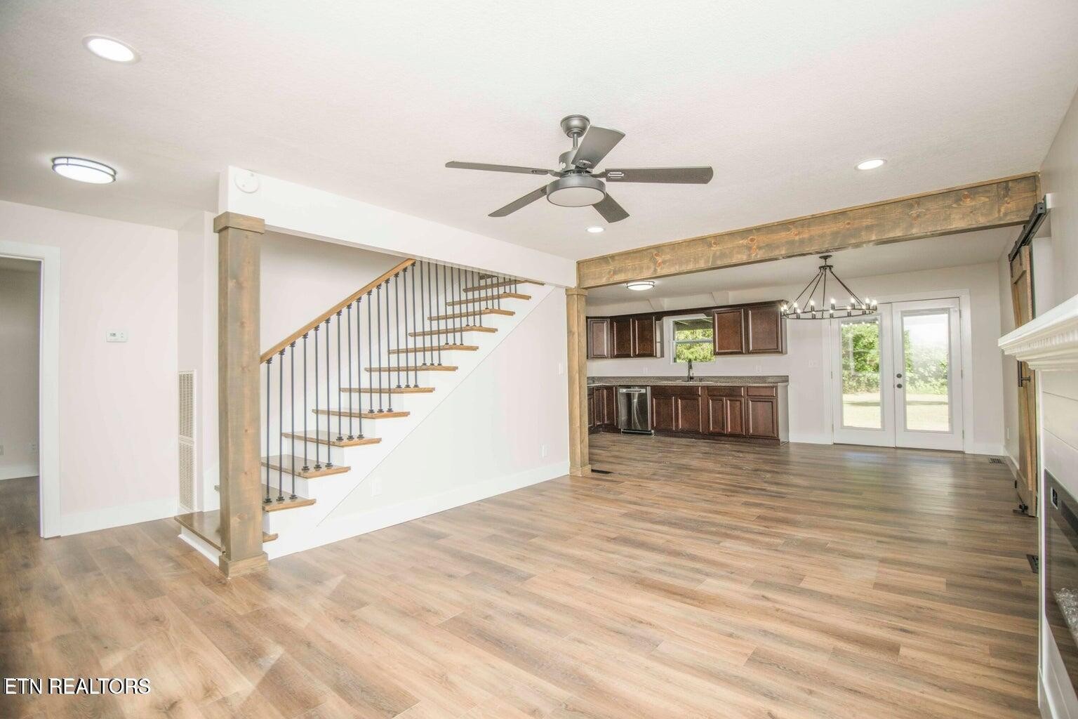 589 Possum Valley Road Maynardville, TN 37807 - Photo 8 of 49 a view of a livingroom with wooden floor and a ceiling fan