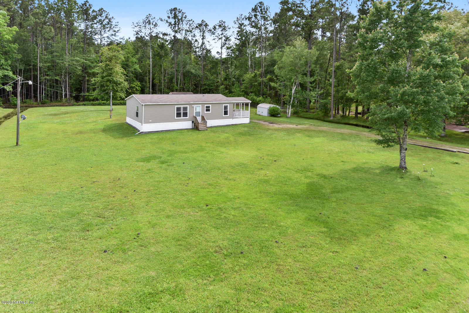 54464 Sherwood Road Callahan, FL 32011 - Photo 1 of 25 a view of a tiny house with a yard