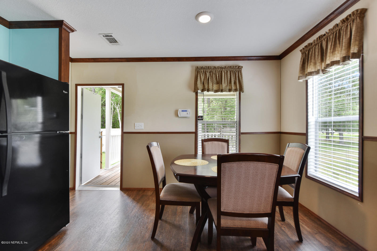 54464 Sherwood Road Callahan, FL 32011 - Photo 12 of 25 a view of a dining room with furniture window and wooden floor