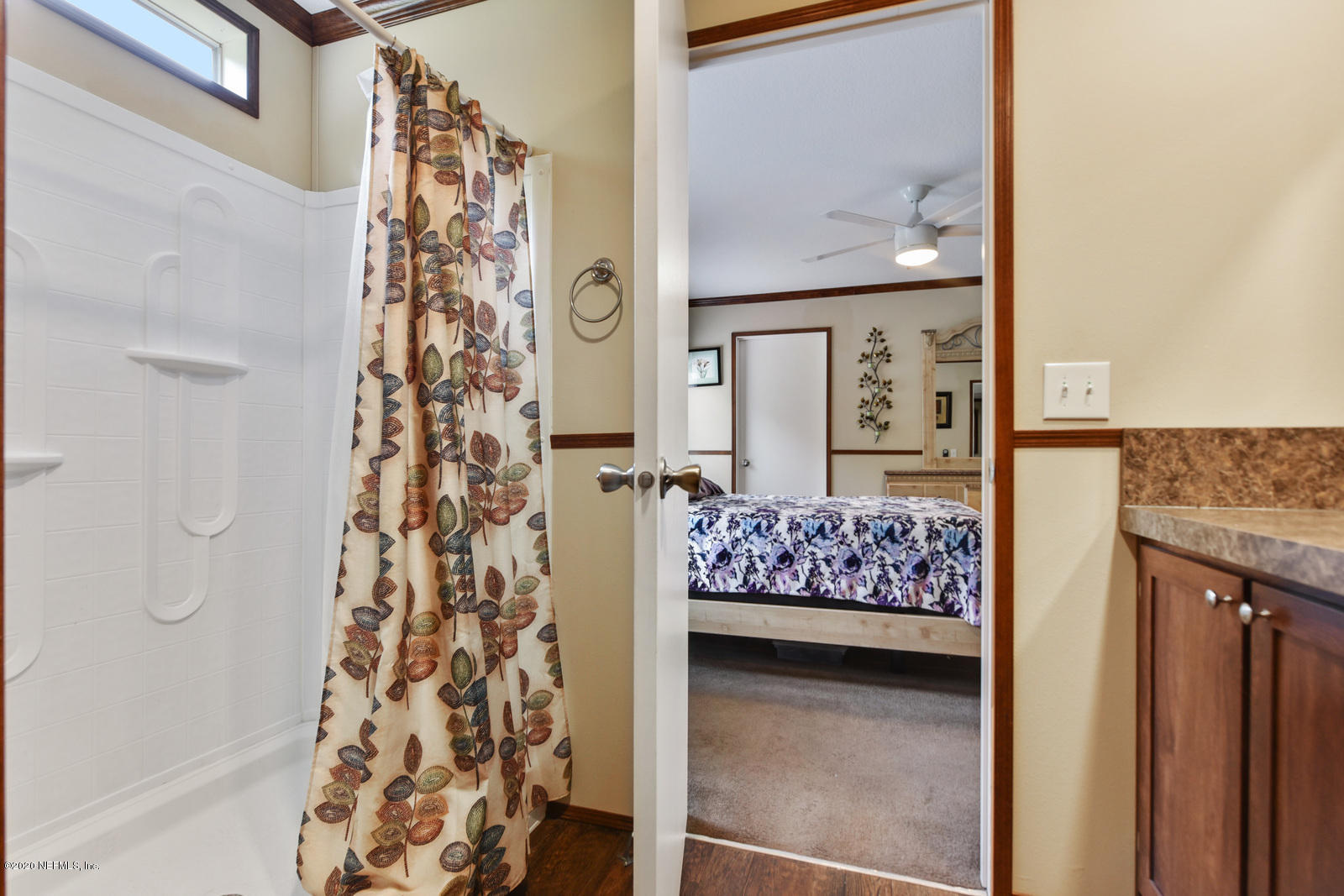 54464 Sherwood Road Callahan, FL 32011 - Photo 16 of 25 a bedroom with a bed and a painting on the wall