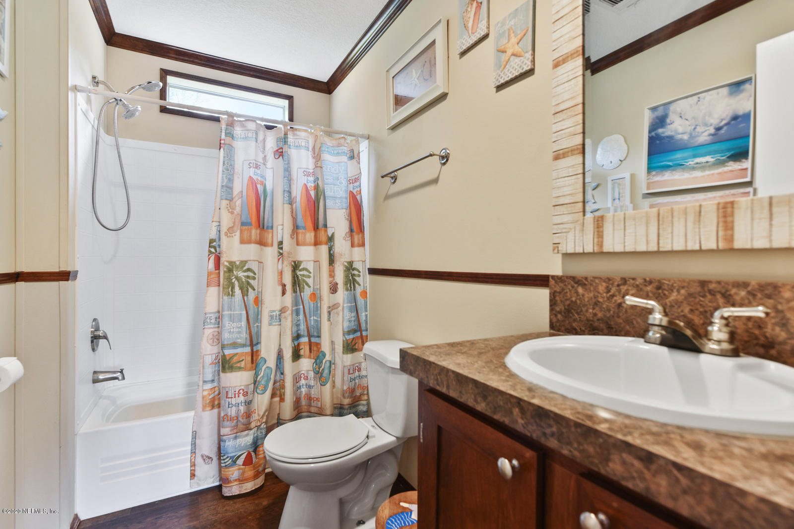54464 Sherwood Road Callahan, FL 32011 - Photo 17 of 25 a bathroom with a granite countertop sink a toilet and shower