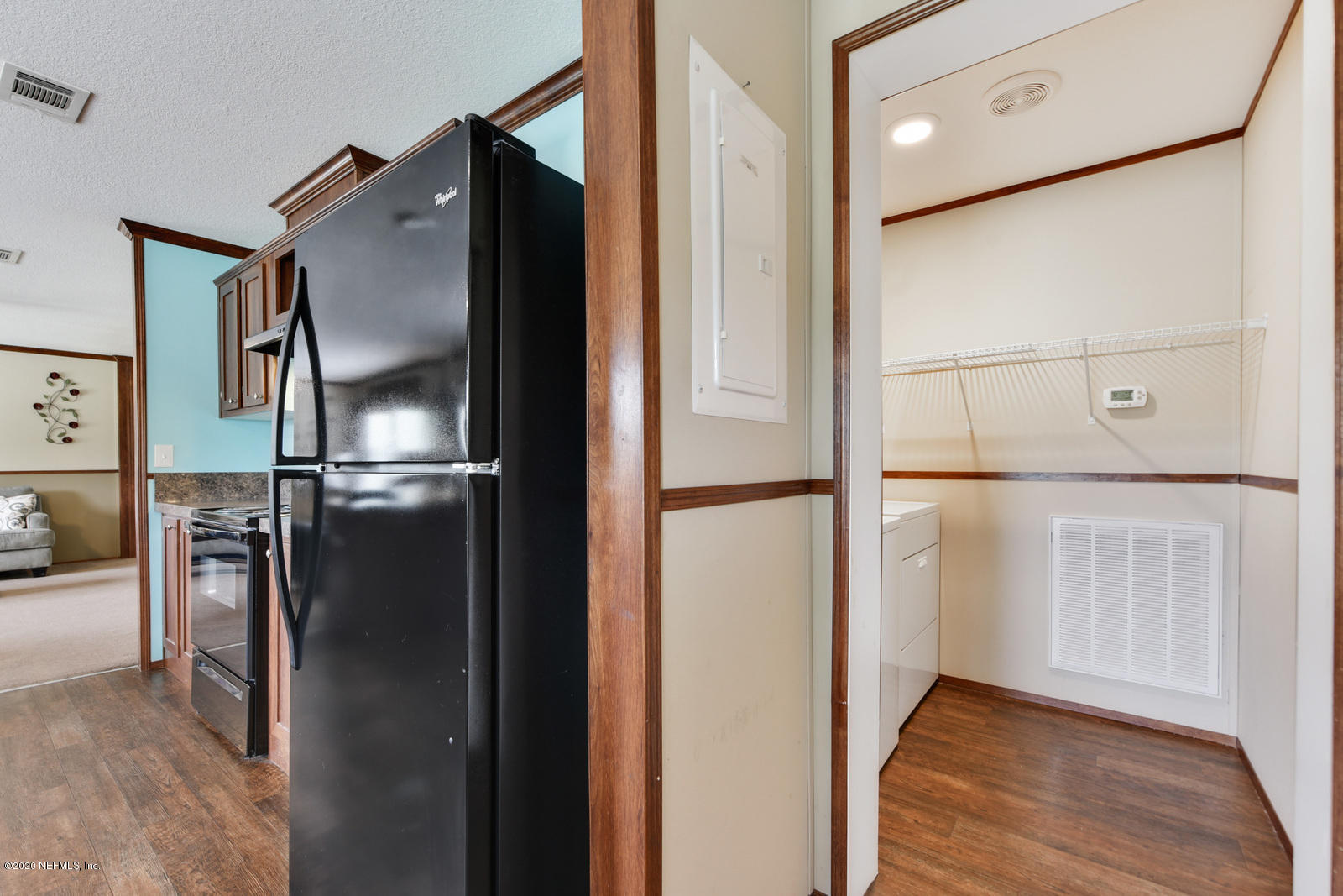 54464 Sherwood Road Callahan, FL 32011 - Photo 20 of 25 an empty room with wooden floor and windows