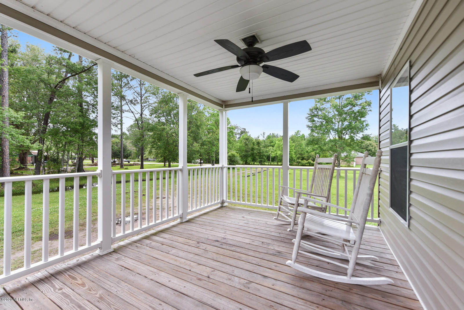 54464 Sherwood Road Callahan, FL 32011 - Photo 21 of 25 a view of a balcony with wooden floor and outdoor space