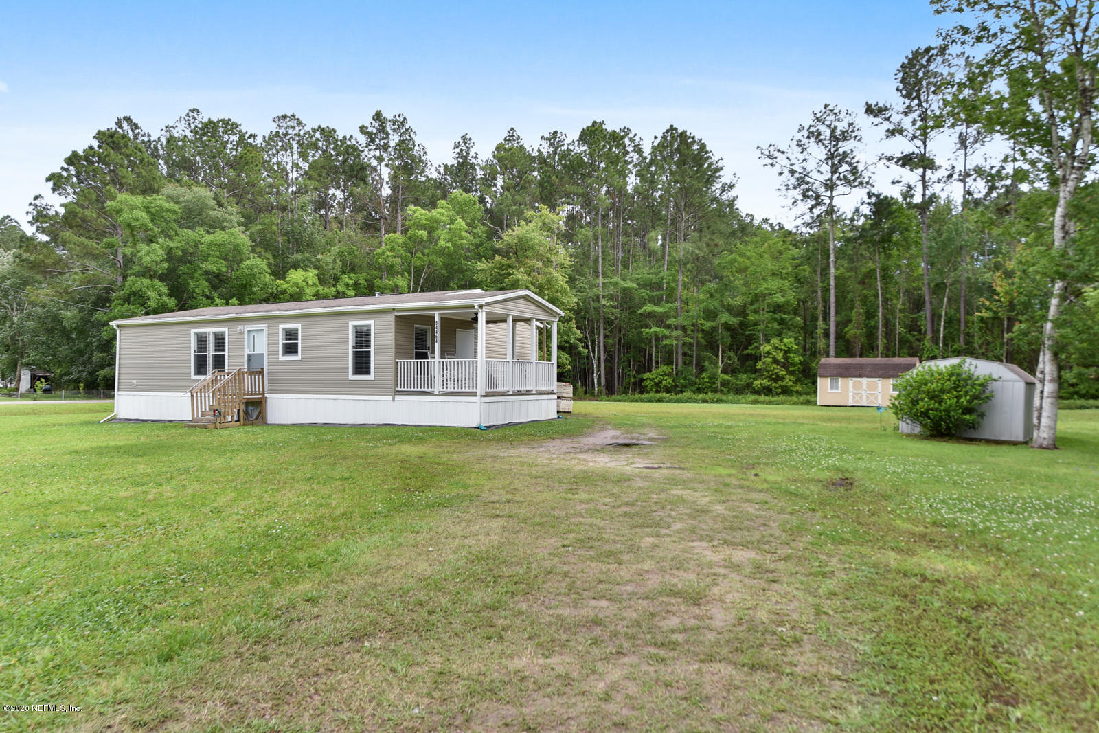 54464 Sherwood Road Callahan, FL 32011 - Photo 3 of 25 a view of a house with backyard and a sitting area