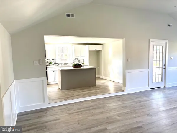 a view of a kitchen with wooden floor and a kitchen