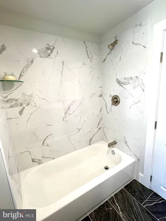 a bathroom with a bathtub and shower