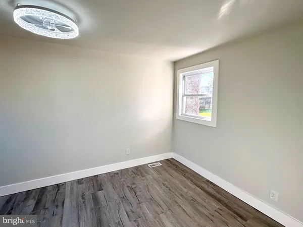 a view of a room with wooden floor and windows